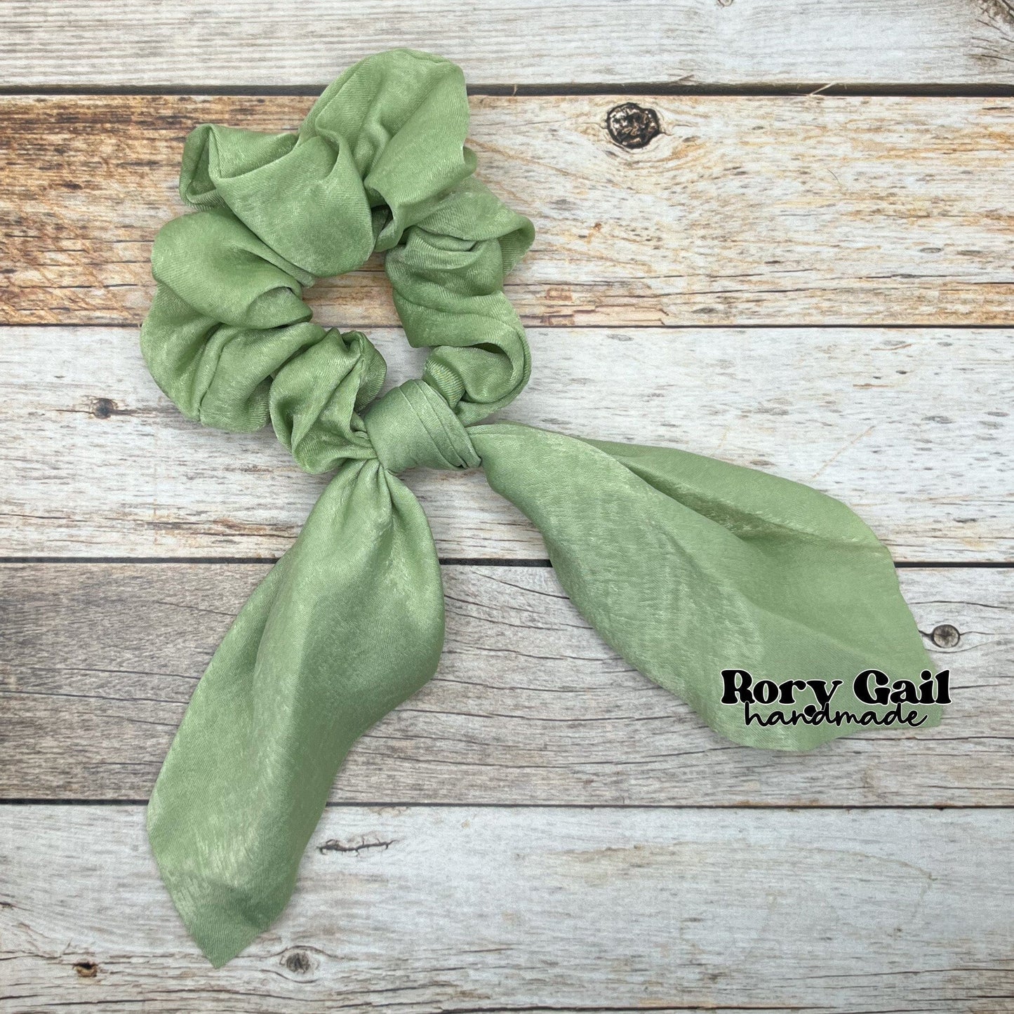 Rory Gail Handmade Satin Knotted Bow Scrunchie in the color, Sage