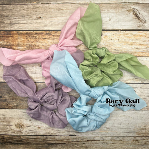 Rory Gail Handmade Satin Knotted Bow Scrunchies in Pastel Pink, Sage, Lavender, and Pastel Blue