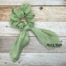 Load image into Gallery viewer, Rory Gail Handmade Satin Knotted Bow Scrunchie in the color, Sage
