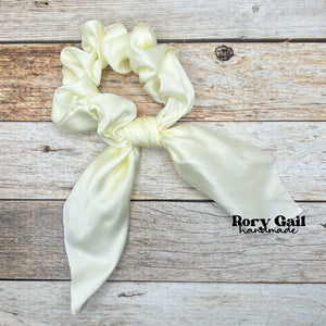 Rory Gail Handmade Satin Knotted Bow Scrunchie in the color, Vintage White